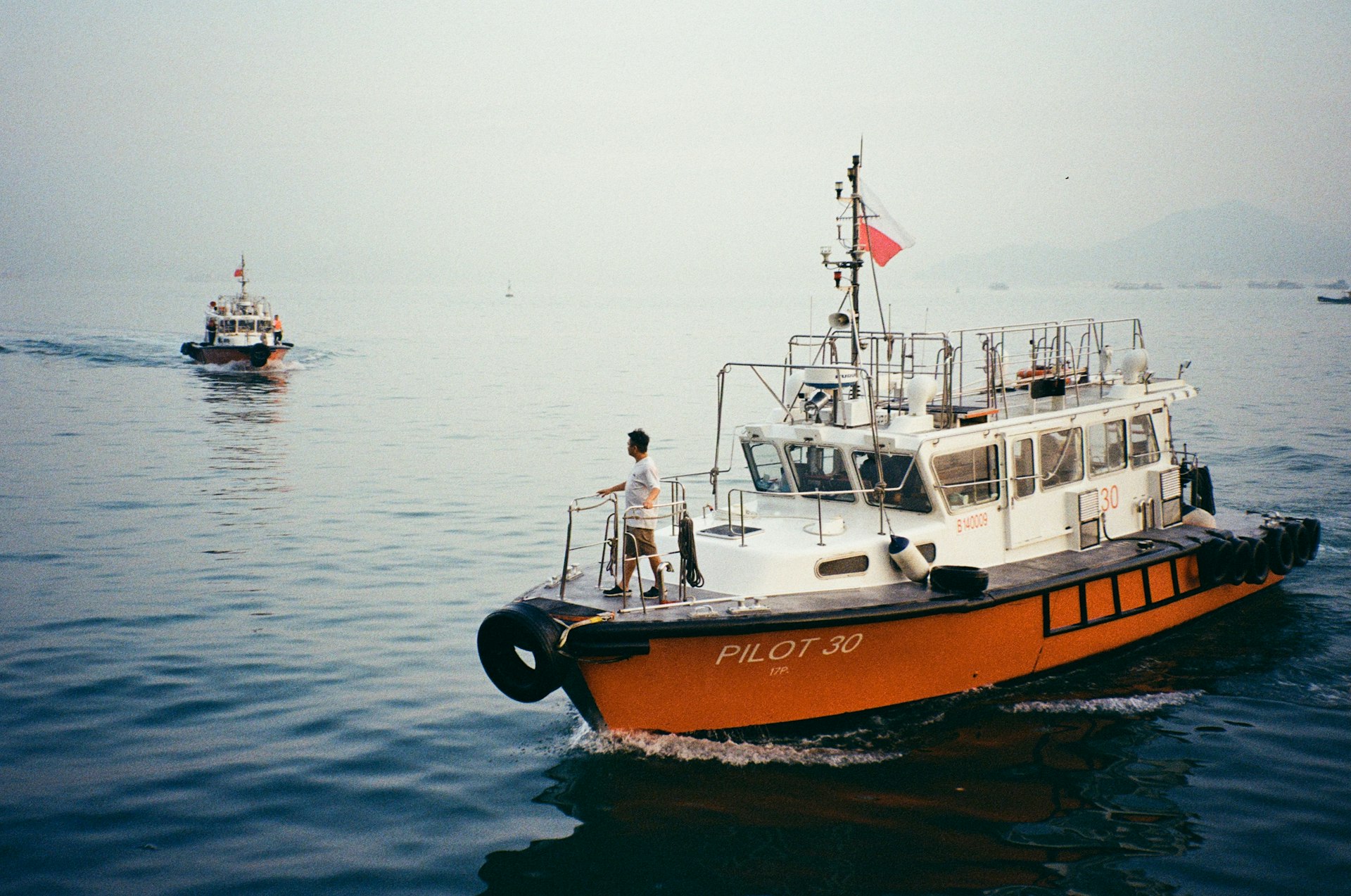 Two pilot boats are sailing on the water.